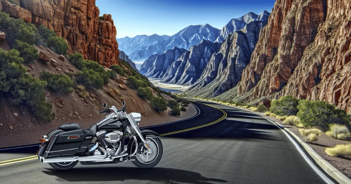 A late model, black Harley Fatboy against a mountainous landscape on a canyon road